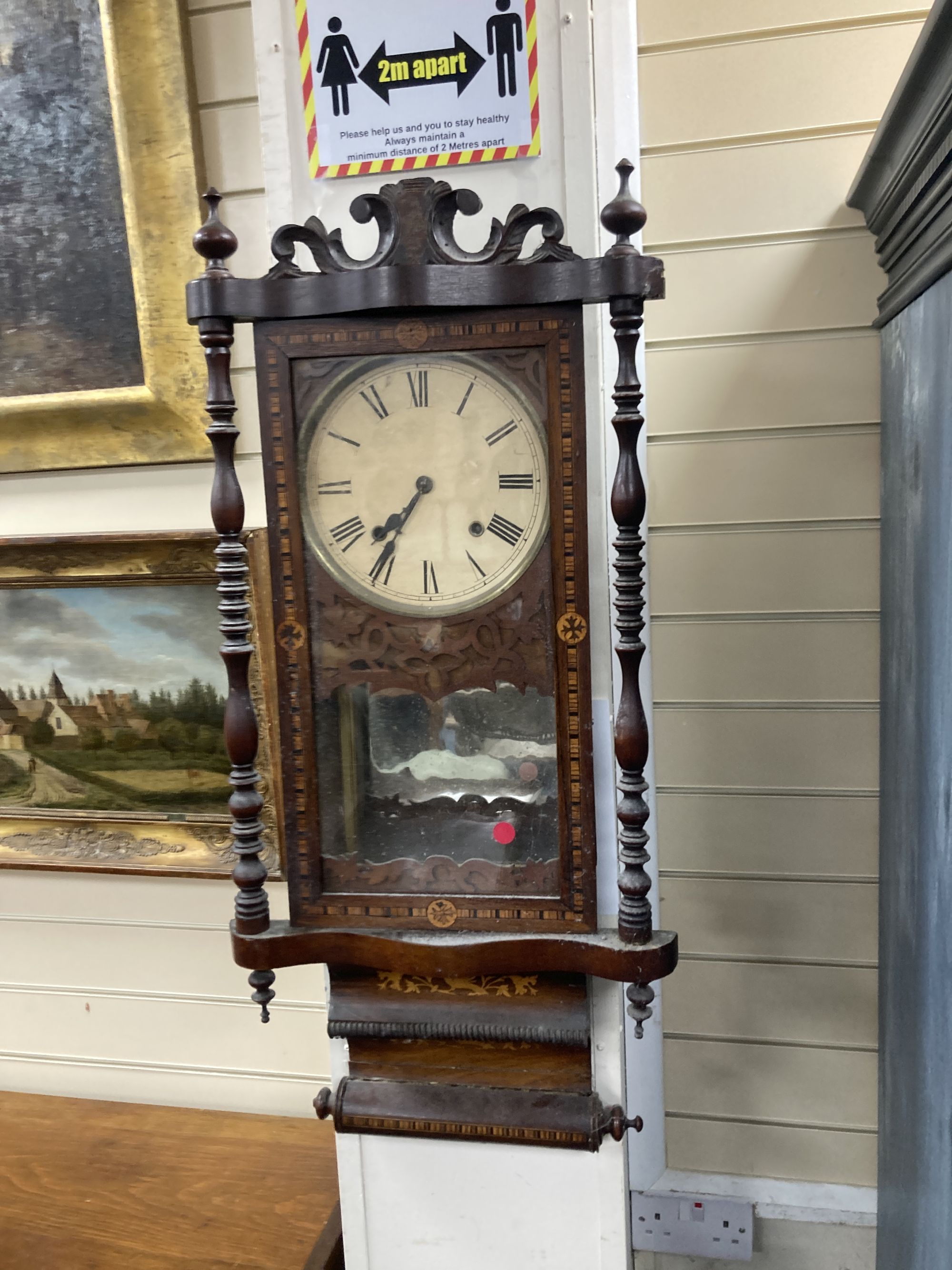 A 19th century American simulated rosewood wall clock, height 84cm, a 19th century inlaid wall clock and a mahogany pedestal cupboard